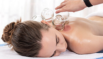 Woman Getting Cupping Treatment At a Spa. Cupping Therapy. Treatment used in Traditional Chinese Medicine for pain relief and other health benefits.